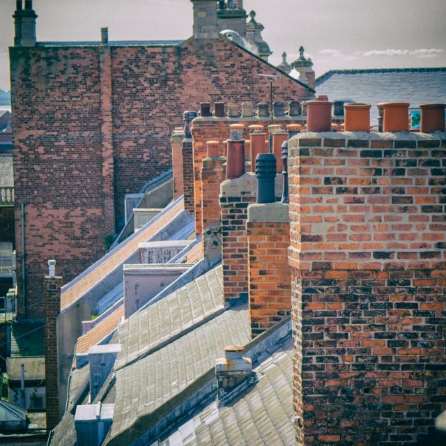 row-of-repaired-brick-chimneys